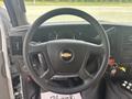 Close-up view of the steering wheel and dashboard of a 2020 Chevrolet Express featuring gauges and controls