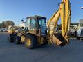 2007 Komatsu WB156PS-5 backhoe loader with a yellow body and a front bucket and rear excavator arm