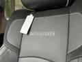 Close-up of a leather seat in a RAM 5500 truck featuring an embossed LARAMIE logo and a tag attached to the seat