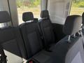 Interior view of the seating area in a 2025 Ford Transit T-350 featuring three seats with black fabric upholstery and seatbelts