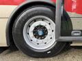Close-up of a wheel and tire from a 2016 Grande West Vicinity bus featuring a silver rim and a black tire with visible tread design