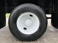 Close-up of a white wheel and tire from a 2012 International 7400 featuring a Continental HDR1 tire tread pattern and a multi-stud wheel hub design