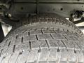 Close-up of the two rear tires of a 2023 Ford F-450 Super Duty showcasing their tread pattern and surface details