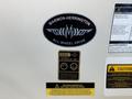 Marmon-Herrington All Wheel Drive badge with operator instructions and safety warnings on a 2009 International 3000 CE vehicle