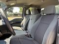 A 2019 Ford F-150 interior featuring two front seats with grey fabric upholstery and seatbelts visible