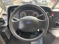 The interior view of a 2018 Ford Econoline showing the steering wheel dashboard and instrument cluster with various gauges and controls