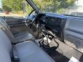Interior of a 2004 Ford F-750 featuring a driver’s seat a steering wheel dashboard controls and gear shifter