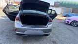 A 2018 Hyundai Sonata with the trunk open showing ample storage space inside