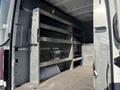 Interior view of a 2024 Mercedes-Benz Sprinter 2500 showing metal shelves and storage racks installed in the cargo area