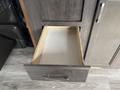 An empty wooden drawer partially pulled out from a cabinet in a 2021 Jayco Jay Flight