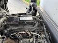 An engine compartment of a 2014 Hino 195 showing various components including hoses wires and a labeled electronic control unit