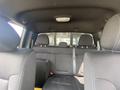 Interior view of a 2014 Ford F-150 showing two front seats and a rear bench seat with black fabric upholstery and seatbelts