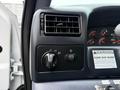 Dashboard controls of a 2001 Ford F-350 featuring climate control knobs and warning labels