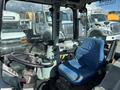 Interior view of a 2010 New Holland T4050 tractor showing the seat and steering wheel with control panel visible