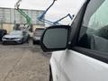 A 2021 Mercedes-Benz Metris with a close-up view of its side mirror reflecting raindrops