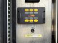 A control panel with buttons labeled for tool operation and a switch labeled MASTER SWITCH mounted on a metal surface