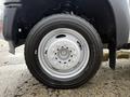 2012 Ford F-550 tire and wheel assembly showing a white rim with visible lug nuts and a black Michelin tire