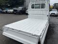 A 2008 Suzuki Carry pickup truck with an empty cargo bed featuring a white metal surface and drop-down tailgate