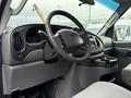 Interior view of a 2006 Ford Econoline showing the dashboard steering wheel and center console with cup holders
