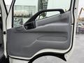 Interior door panel of a 2015 Hino 195 featuring a gray and black design with a handle and armrest