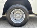Close-up of a large tire mounted on a silver alloy wheel designed for a 2011 Workhorse W62 with a rugged tread pattern for enhanced traction