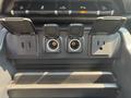 Dashboard panel of a 2017 Chevrolet Silverado 1500 with two USB ports a power outlet and two type connectors with flaps open