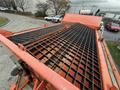 A close-up view of the flattened metal bed of a 2012 International 7400 with a grid pattern and orange frame detailing