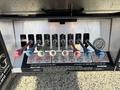 Control levers in various colors for a Freightliner M2 106 truck located in the foreground with labels indicating their functions for operating the vehicle
