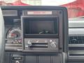 Dashboard of a 2002 GMC C7500 with gauges for speed and engine performance and controls for temperature and defrost airflow