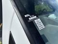 A 2020 Chevrolet Express with a certificate of approval sticker attached to the windshield displaying the months July to December