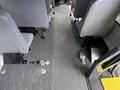 Interior of a 2013 Chevrolet Express with gray seats visible and a rubber floor mat running down the center