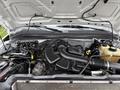 Engine compartment of a 2008 Ford F-250 SD showing various components including the engine block intake manifold and hoses