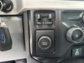 Control panel of a 2023 Ford F-450 Super Duty featuring buttons for adjusting settings and a drive mode selector