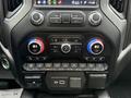The image shows the control panel of a 2022 GMC Sierra 3500HD with various knobs buttons and climate control settings