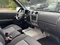 Interior of a 2011 Chevrolet Colorado featuring gray seats a dashboard with controls and a steering wheel