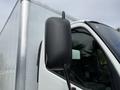 A close-up of the side mirror on a 2018 Hino 195 truck with a black casing and a visible mounting arm