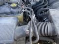 Close-up of the engine components of a 2014 GMC Sierra 1500 showing hoses wires and parts of the intake system
