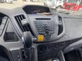 Dashboard of a 2019 Ford Transit featuring a radio control panel gear shift and various buttons for audio and vehicle settings