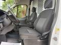 Interior view of a 2021 Ford Transit showcasing two black fabric seats with a textured design and a steering wheel on the left side