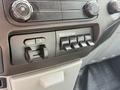 Control panel of a 2011 Ford F-350 SD featuring switches for beacon and auxiliary controls