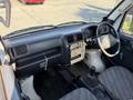 Interior view of a 2008 Suzuki Carry showing the dashboard gear shift and seats