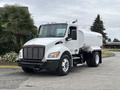 A 2025 Peterbilt 536 white truck designed for water transport with a tank mounted on the chassis and distinct front grille and headlights