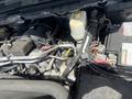 Close-up view of the engine compartment of a 2016 RAM 5500 showing various components including the engine, battery, and fluid reservoir