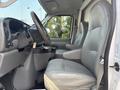 Interior of a 2008 Ford Econoline featuring two gray leather seats and a steering wheel with dashboard controls