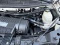 Engine compartment of a 2019 Chevrolet Express showcasing the engine components and related parts