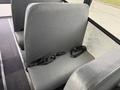 Interior view of a gray bench seat with seatbelts in a 2022 Freightliner B2 bus