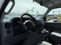 Interior view of a 2019 Ford Econoline showing the steering wheel dashboard and console area