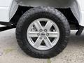 Close-up of a wheel on a 2021 Ford F-150 featuring a silver rim and an aggressive all-terrain tire with the brand name and model printed on the sidewall
