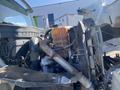 Engine of a 2014 International 7400 showing various components including a radiator coolant reservoir and metal piping