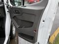 Interior side door panel of a 2020 Ford Transit featuring a gray handle and storage compartment